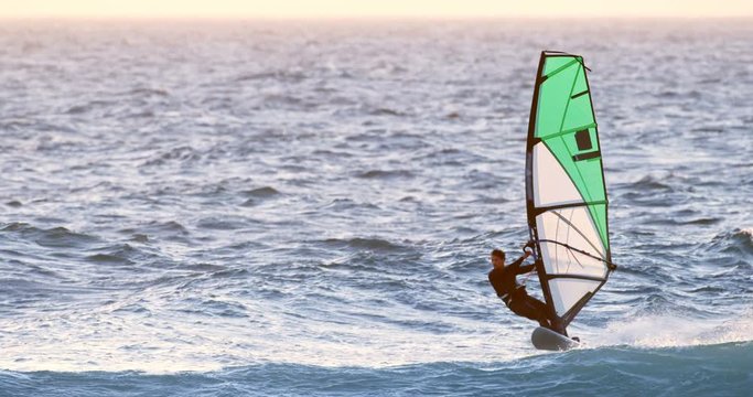 Male surfer windsurfing in the beach 4k