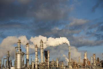 Carbon emissions, smokestack plume with blue sky and clouds. Petrochemical refinery, Corpus Christi.