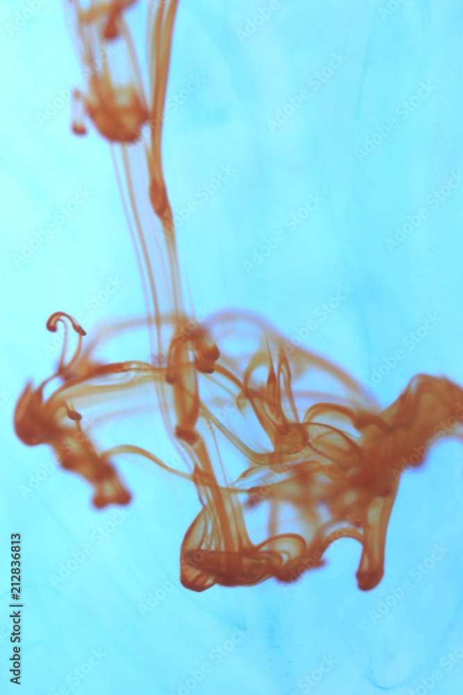 Poster orange ink drop dynamic motion. ambient background.