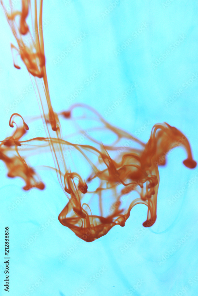 Poster orange ink drop dynamic motion in water. soft ambient background.