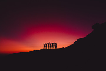 Bright sunset or sunrise and silhouette of people