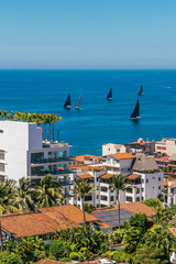 Skyline viewof Puerto Vallarta during a sailboat regatta race on the ocean