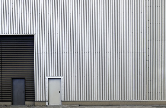 Metallic wall with striped line texture with closed doors.