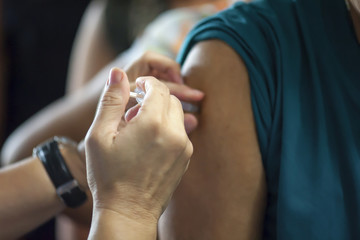 Obraz na płótnie Canvas Doctors provide vaccinations to the public to help prevent influenza. Prevention concept