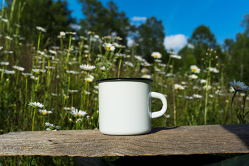White campfire enamel mug mockup with daisy field