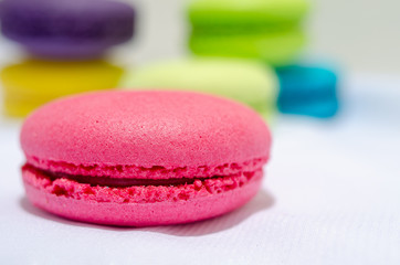 pink macaroon on blurred multicolored background