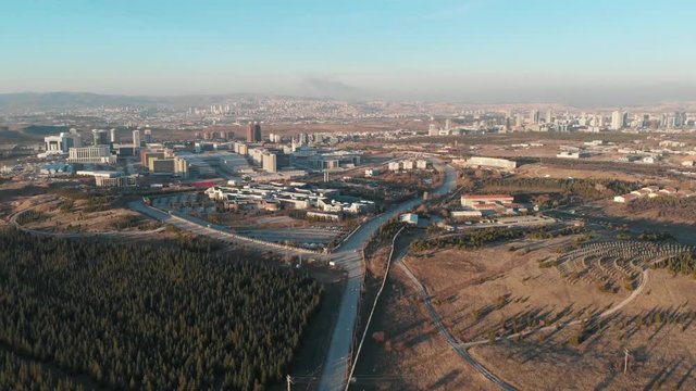 Various drones shots including a university campus main entrance, shopping mall, residential area and a mosque.