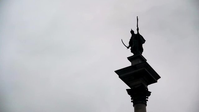 Extreme long shot of King Zygmunt's Column in Warsaw, Poland as clouds pass by in the background