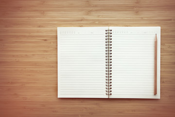 Notebook on wood table background.