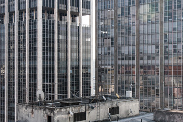 View of office huge office buildings in downtown San Paolo, Brazil from the roof of an aged commercial concrete building.