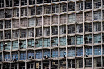 Fototapeta premium Old business building colored by red, green and blue blinds