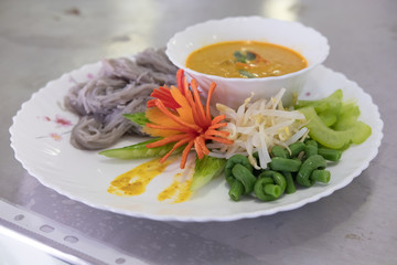 Thai vermicelli with natural herbal color. rice noodle, vegetable & curry soup