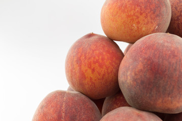 Slope of a mountain of peaches on a white background