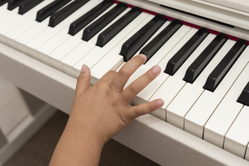 電子ピアノを弾く子供の手元