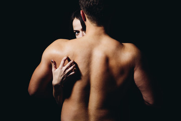 Loving his body. Woman hand touch man torso, rear view. Couple in love. He is absolutely mine. Back disease and treatment. Massage for back health. Sex games