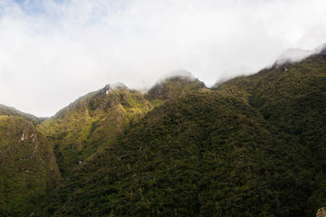 Landscape of green Andes mountains and clouds on the background. Peru. No people.