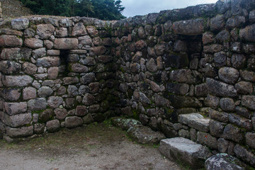 Stone magical ancient ruins along the paved path Inca Trail to Machu Picchu in Peru.