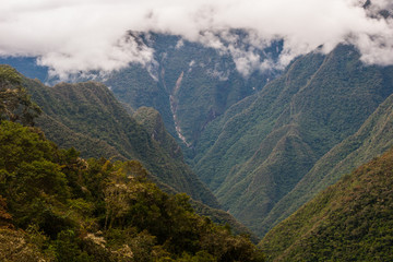 Fototapeta premium Clouds over the green valley of the Andes in Peru along the Inca Trail. South America. No people.