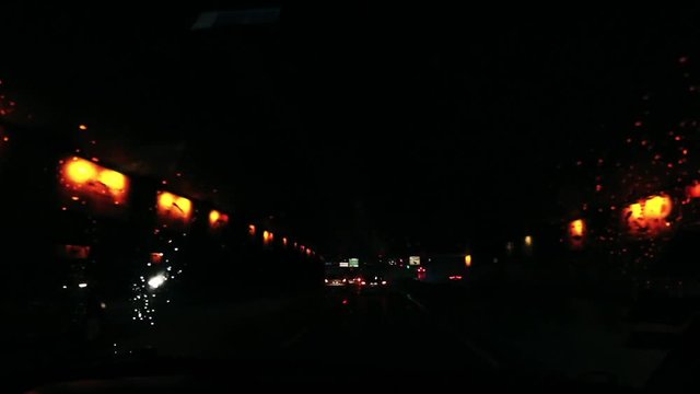 Driving car seen from passenger sit in paris peripherique by sunset night with clowdy sky