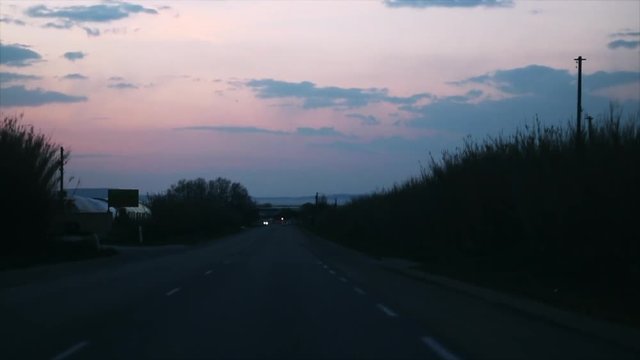 driving during the sunset in Cote d'azur south of France seen from passenger sit pink cloudy sky
