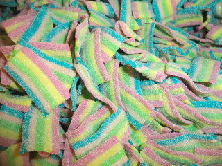 colorful striped sweets in sugar