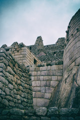 Stone magical ancient ruins along the paved path Inca Trail to Machu Picchu in Peru.