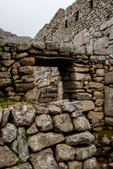 Stone magical ancient ruins along the paved path Inca Trail to Machu Picchu in Peru.
