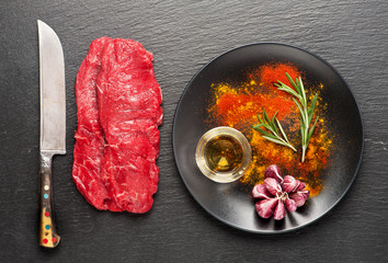 Raw beef steaks, herbs and seasonings