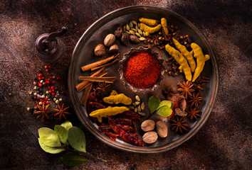 Indian spices and herbs on a dark concrete background
