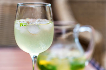 Refreshing Mojito cocktail in glass and jug close