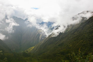 Panoramic view from the Inca Trail of the Sacred Valley with intense low clouds on the Andes mountains. Peru. South America. No people.