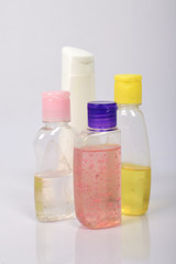 Many white plastic bottles on grey background. 