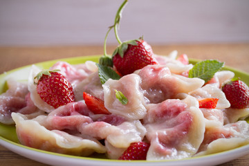 Delicious strawberry dumplings. Dumplings with berries. Varenyky, vareniki, pierogi, pyrohy. horizontal