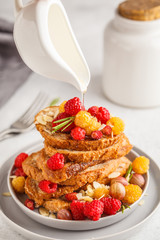 French toast with berries and syrup, vertical. Healthy vegan food concept.