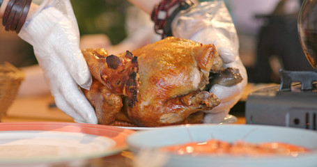 Woman tearing grilled in Chinese restaurant