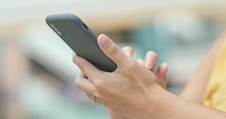 Close up of woman use of mobile phone in shopping mall