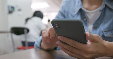 Woman touch on cellphone in restaurant