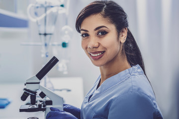 Inspired bioengineer. Dark-haired young promising bioengineer feeling very inspired while sitting...