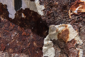 Worn rusty metal surface with pieces of old torn paper. Background texture. Perfect grunge wallpaper. No people.