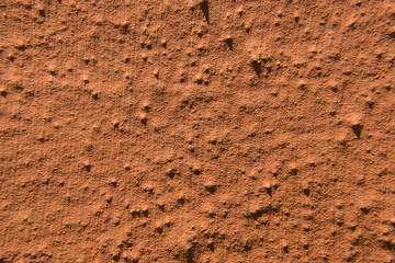 Worn old rough concrete wall with orange peeling paint. Beautiful grunge wallpaper background texture. No people.