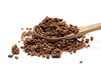 Crunchy chocolate granola, muesli pile with wooden spoon isolated on white background