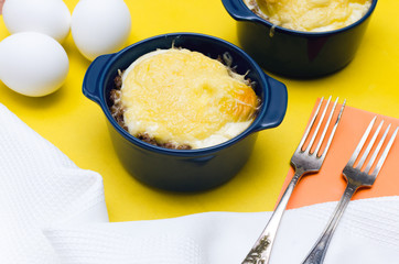 Buckwheat porridge with cheese and egg on yellow background. Healthy food.