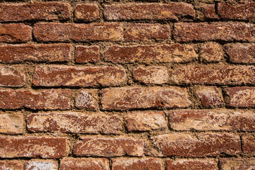 Beautiful wallpaper background of a worn old red brick wall. No people.