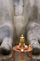 Brass statue infront of a gigiantic monolithic statue of Bahubali, also known as Gomateshwara, Vindhyagiri Hill, Shravanbelgola