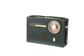 isolated .vintage portable radio covered in green leather / old radio of the 50-60s with a circular dial