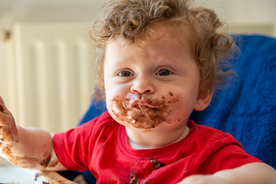 baby is eating a chocolate cake