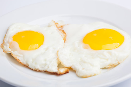 A beautiful photo of a closeup menu of fresh delicious eggs on a plate on a white background