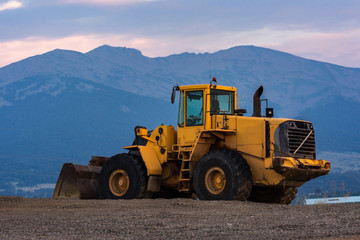 Excavator at the end of a working day in a construction site