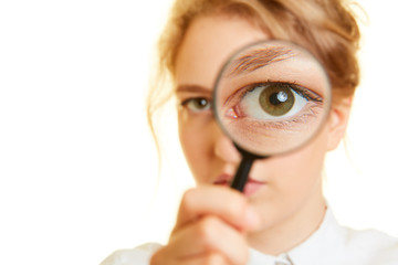 Frau schaut mit Auge durch Lupe als Kontrolle Konzept