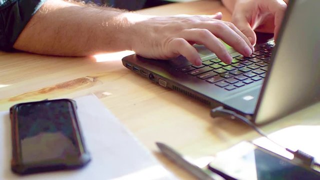 Business concept, hand using laptop at coffee shop, sun flares and toned image and free space for text